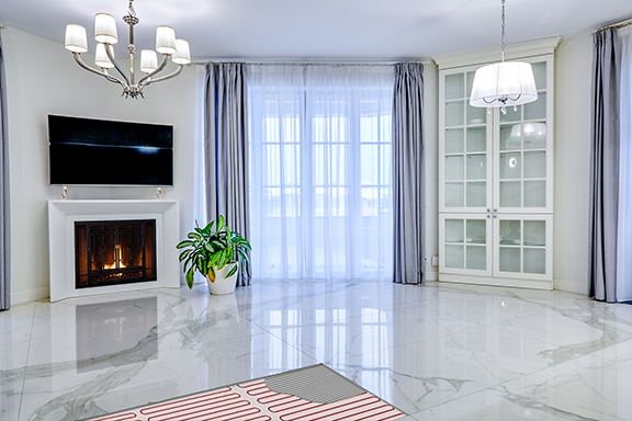 A heated marble floor with cutout showing the heating cable and thinset.