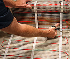 To make a turn, first cut the mesh backing of the floor heating mat.